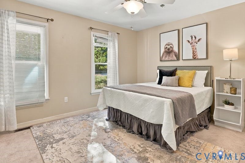 10208 Claybar Trail, Chesterfield, VA 23236 Neutral-toned walls featuring dual windows and a ceiling-mounted light fixture with integrated fan