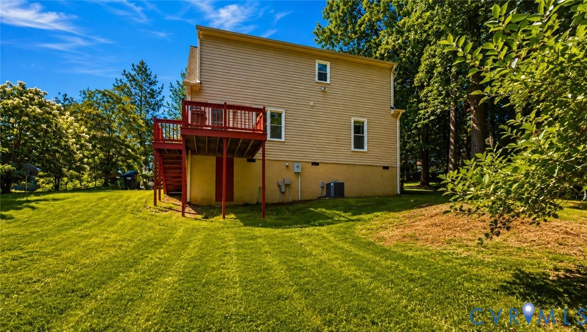 10208 Claybar Trail, Chesterfield, VA 23236 Two-story exterior featuring light-toned horizontal siding, a raised rear deck with stairs, a lawn, and mature perimeter trees