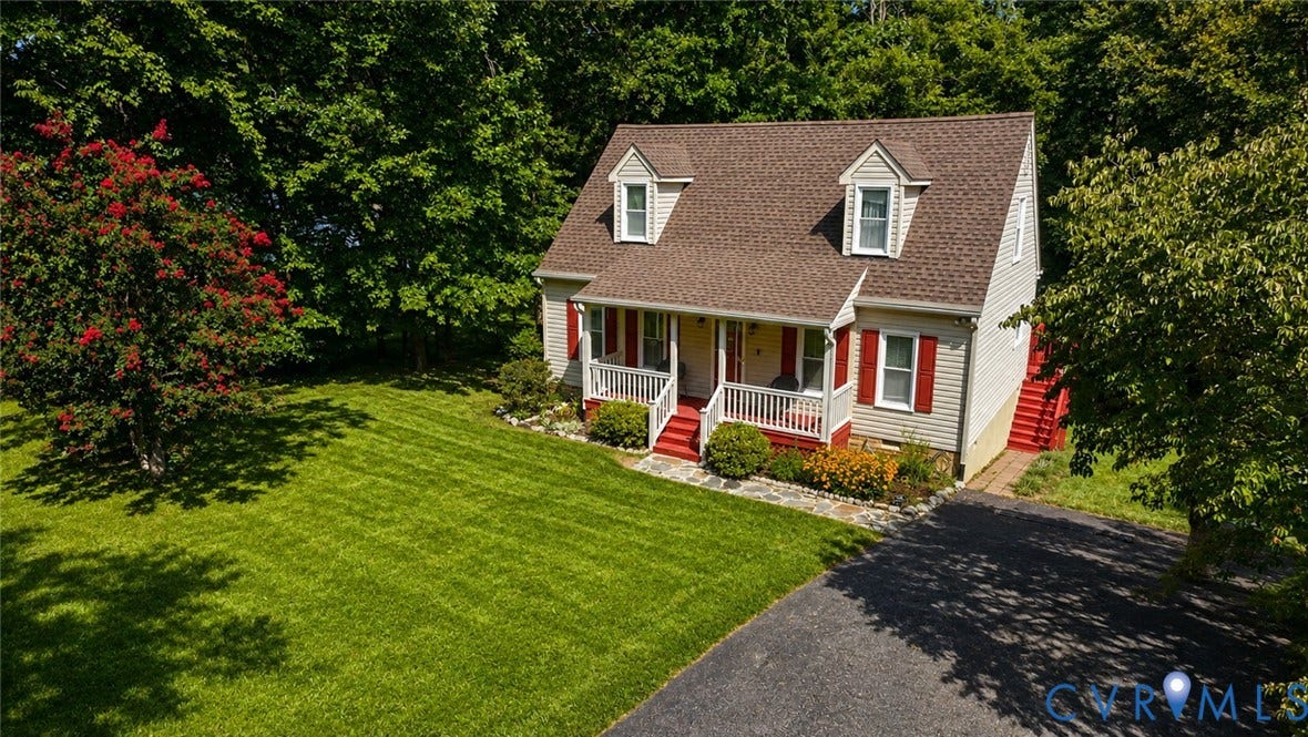 10208 Claybar Trail, Chesterfield, VA 23236 Cape Cod style exterior featuring horizontal siding, twin dormer windows, a covered front porch with railings, a stone walkway, and an asphalt driveway