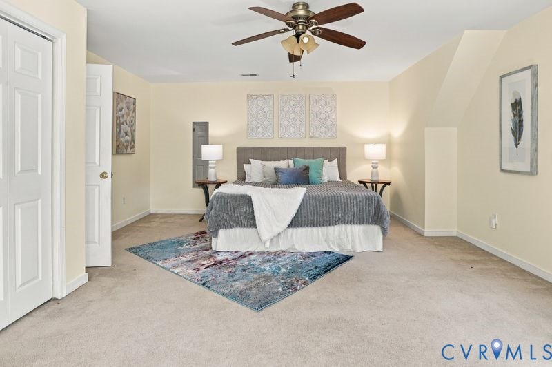 10208 Claybar Trail, Chesterfield, VA 23236 Spacious room featuring neutral carpeting, a multi-blade ceiling fan with integrated lighting, and dual hinged doors