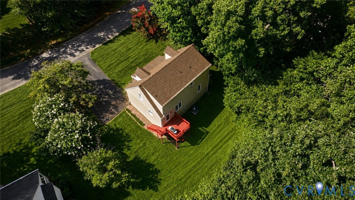 10208 Claybar Trail, Chesterfield, VA 23236 Aerial perspective featuring a multi-story residence with an elevated deck, paved driveway, and expansive lawn surrounded by mature trees