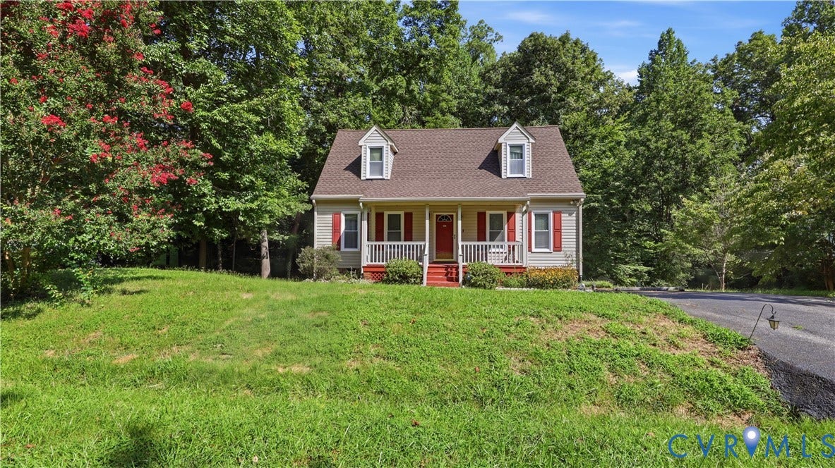 10208 Claybar Trail, Chesterfield, VA 23236 Two-story residence featuring a covered front porch, dual dormer windows, exterior shutters, and a sloped lawn