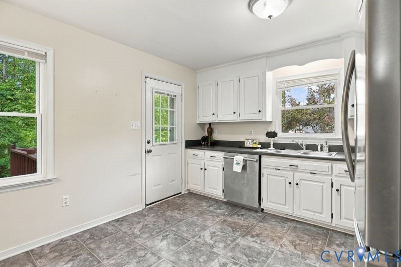 10208 Claybar Trail, Chesterfield, VA 23236 Kitchen featuring white cabinetry, dark stone-style countertops, stainless steel dishwasher, tile flooring, and a glass-paneled exterior door