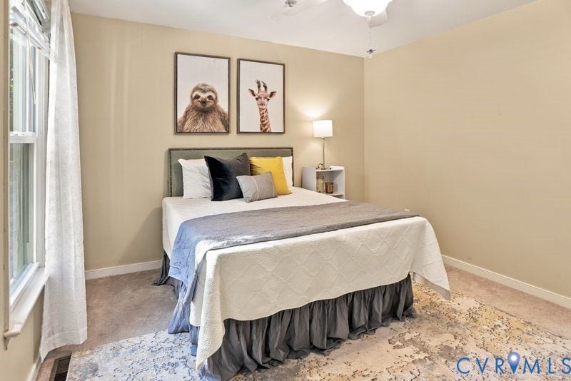 10208 Claybar Trail, Chesterfield, VA 23236 Neutral-toned interior space featuring carpeted flooring, large window with natural light, and a ceiling-mounted light fixture