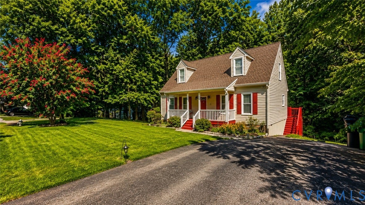 10208 Claybar Trail, Chesterfield, VA 23236 Cape Cod-style residence featuring a covered front porch, dual dormer windows, asphalt shingle roofing, and an attached side staircase