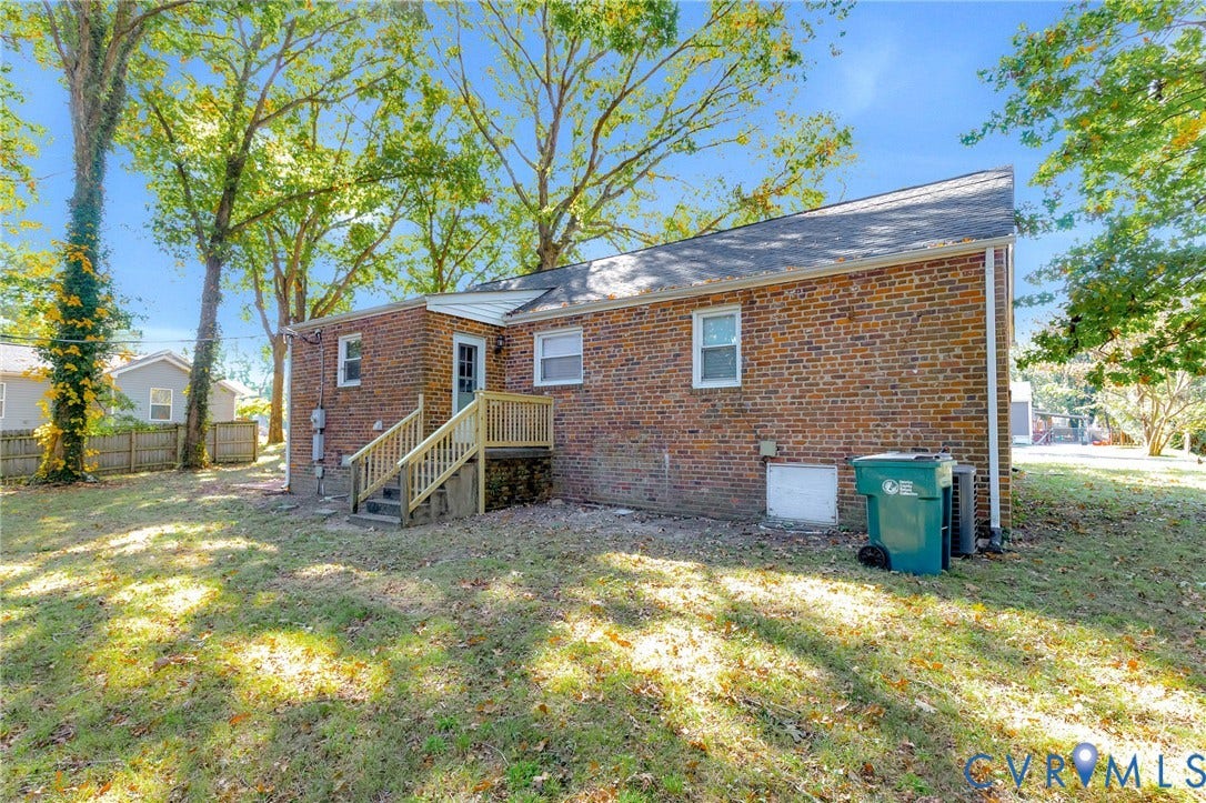 7304 Bowler Street, Henrico, VA 23228 Exterior featuring a brick facade, gabled roofline, and elevated wooden stairs with railing