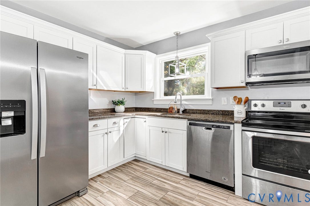 7304 Bowler Street, Henrico, VA 23228 Kitchen featuring white cabinetry, wood-finish flooring, dark stone countertops, stainless steel appliances, and a geometric pendant light fixture