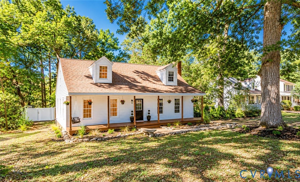 10100 Brittonwood Drive, Chesterfield, VA 23237 Cape Cod-style residence featuring a full-width covered front porch, dual roof dormers, white siding, and stone hardscaping