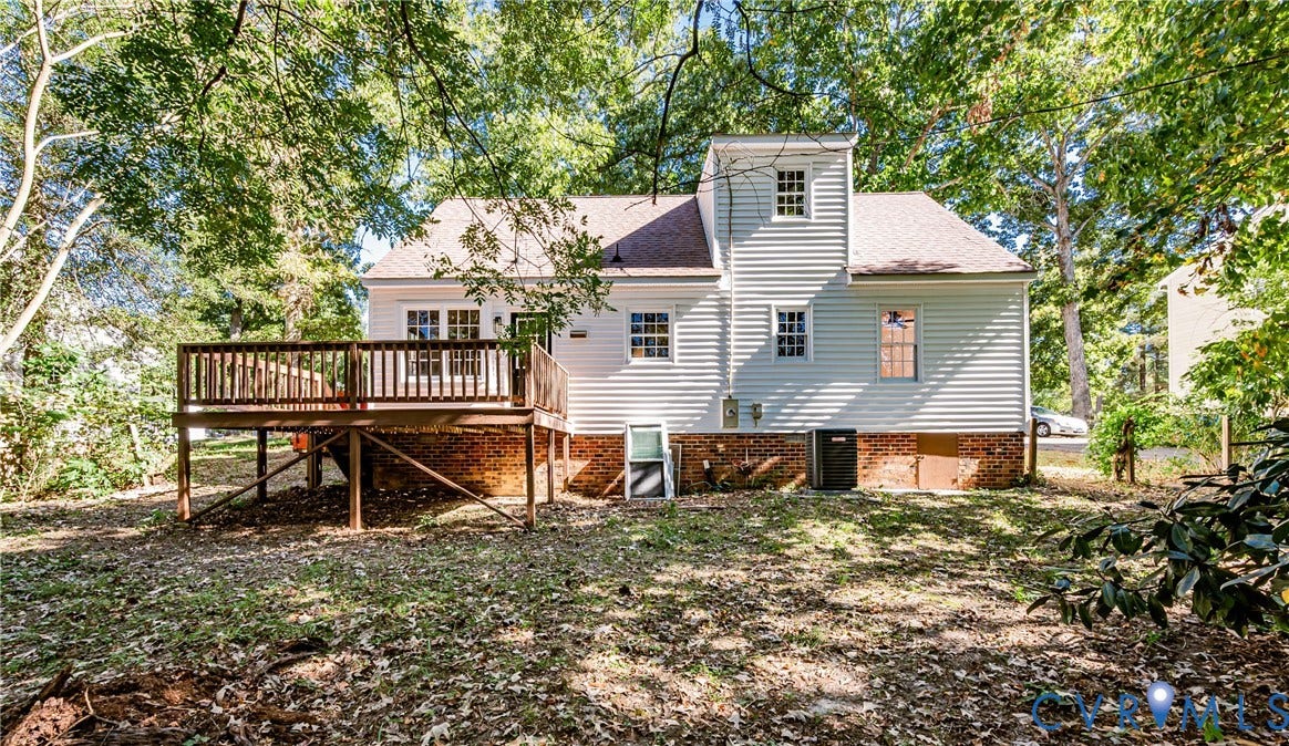 10100 Brittonwood Drive, Chesterfield, VA 23237 Exterior siding featuring a multi-level structure with a brick foundation, elevated wood deck, and mature surrounding trees