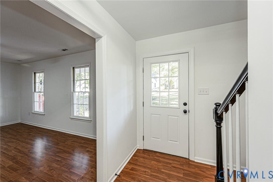 10100 Brittonwood Drive, Chesterfield, VA 23237 Entryway featuring wood-finish flooring, a six-pane glass inset entry door, and a staircase with a dark-finished newel post and white balusters