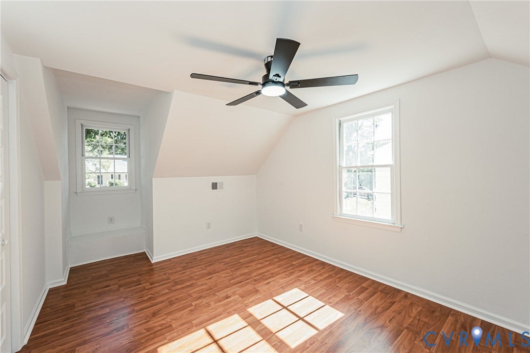 10100 Brittonwood Drive, Chesterfield, VA 23237 Room featuring wood-finish flooring, two double-hung windows, and a ceiling fan with integrated lighting