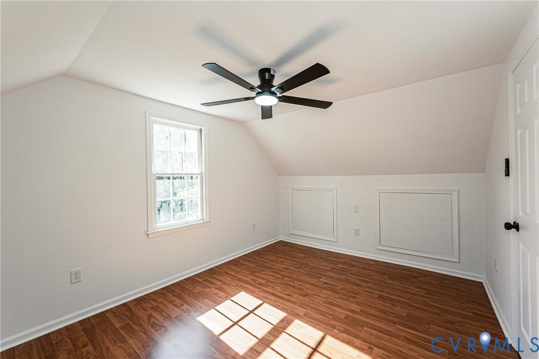 10100 Brittonwood Drive, Chesterfield, VA 23237 Room featuring sloped ceilings, wood-finish flooring, a multi-blade ceiling fan with an integrated light fixture, and two built-in access panels