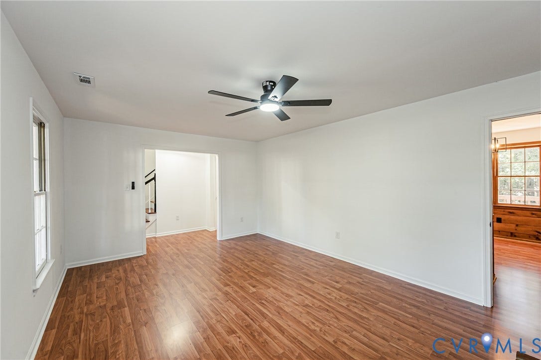 10100 Brittonwood Drive, Chesterfield, VA 23237 Interior space featuring wood-finish flooring, white walls, and a ceiling-mounted fan with integrated light fixture