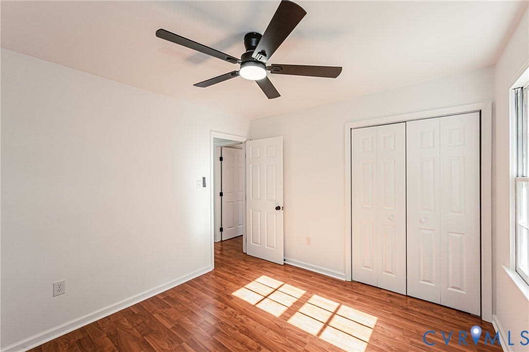 10100 Brittonwood Drive, Chesterfield, VA 23237 Wood-finish flooring, multi-paneled closet doors, six-panel interior door, and a five-blade ceiling fan with integrated lighting
