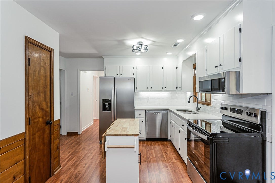 10100 Brittonwood Drive, Chesterfield, VA 23237 Kitchen featuring white cabinetry, wood-finish flooring, stainless steel appliances, subway tile backsplash, and a butcher block island