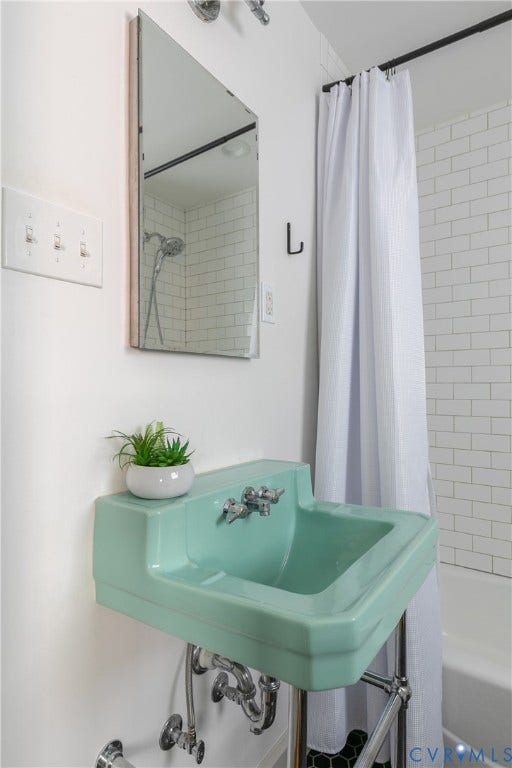 4710 Park Avenue, Mary Munford / Near West End, Richmond, VA 23226 Wall-mounted mint-green porcelain pedestal sink with polished chrome hardware, rectangular mirror, and tub surround featuring white subway tile