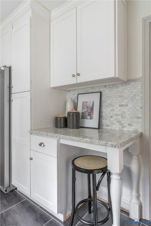 4710 Park Avenue, Mary Munford / Near West End, Richmond, VA 23226 Built-in cabinetry featuring Shaker-style doors, stone countertop, decorative turned post leg, and mosaic tile backsplash