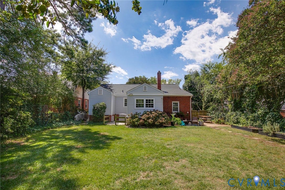 4710 Park Avenue, Mary Munford / Near West End, Richmond, VA 23226 Expansive backyard featuring a manicured lawn, mature trees, brick and siding exterior, and a chimney