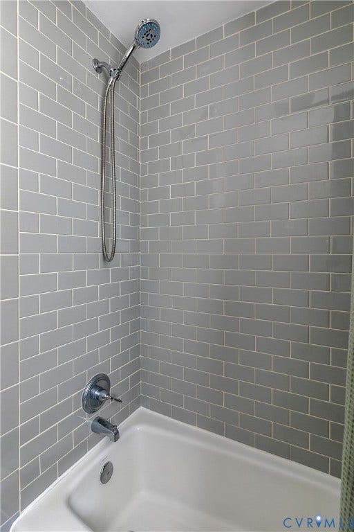 4710 Park Avenue, Mary Munford / Near West End, Richmond, VA 23226 Shower and bathtub combination featuring gray subway tile surround, chrome hand-held shower head, and chrome faucet hardware