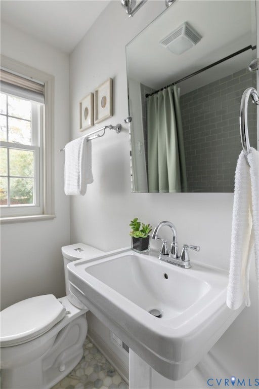 4710 Park Avenue, Mary Munford / Near West End, Richmond, VA 23226 Wall-mounted pedestal sink with polished chrome widespread faucet, frameless mirror, hexagonal tile flooring, and subway tile shower surround