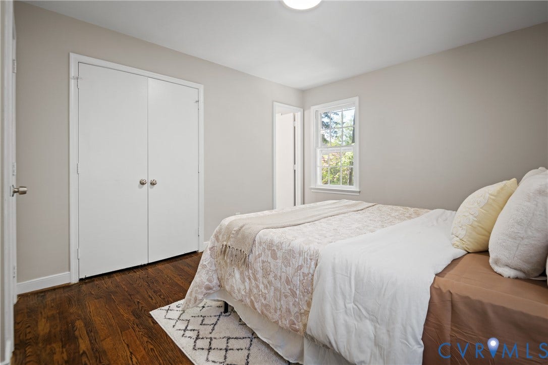 9010 Fawn Lane, Henrico, VA 23229 Room featuring wood-finish flooring, double-door closet, neutral wall paint, and a single-hung window with exterior greenery
