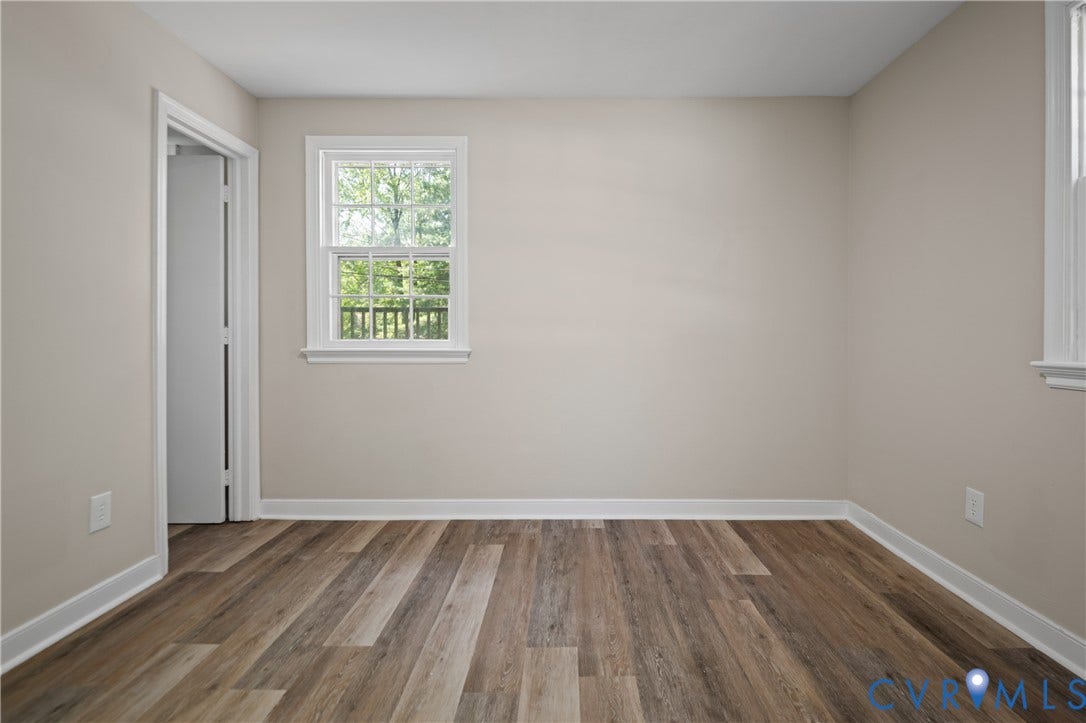 9010 Fawn Lane, Henrico, VA 23229 Neutral-toned interior space featuring wood-finish flooring and double-hung windows