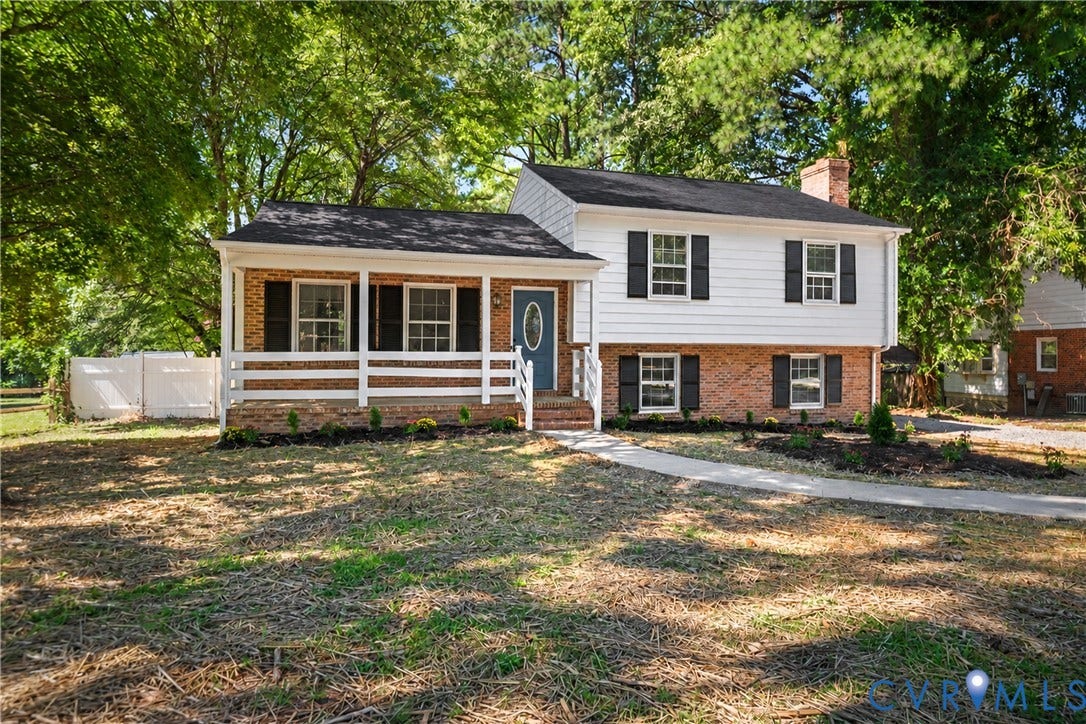 9010 Fawn Lane, Henrico, VA 23229 2026 Roof, Split-level exterior featuring brick and horizontal siding, a covered front porch with white railing, and dark shutters