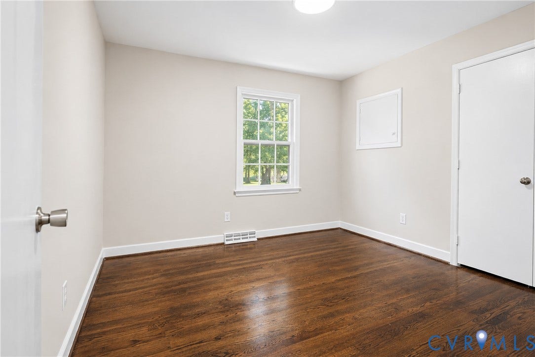 9010 Fawn Lane, Henrico, VA 23229 Room featuring wood-finish flooring, neutral wall paint, and a single-hung window with a multi-pane upper sash