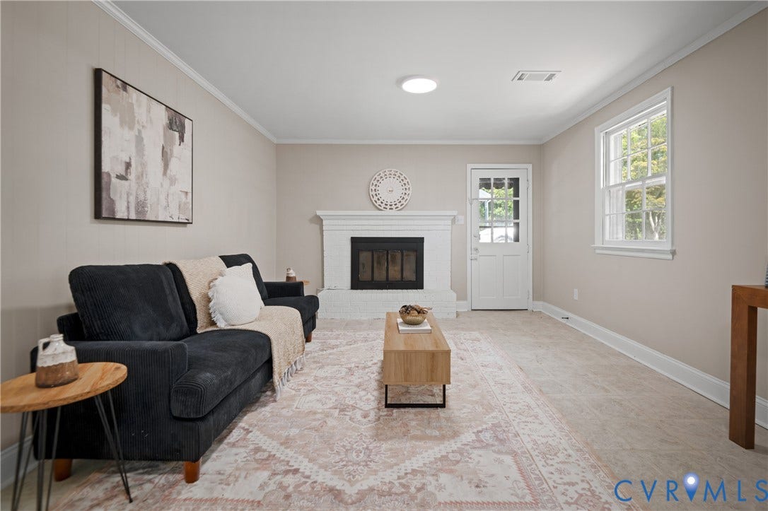 9010 Fawn Lane, Henrico, VA 23229 White painted brick fireplace, multi-pane glass entry door, neutral wall color, and multi-pane window