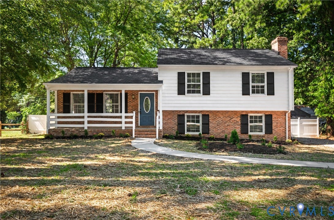 9010 Fawn Lane, Henrico, VA 23229 2026 Roof, Two-story exterior featuring a brick and horizontal siding facade, a covered front porch with a white rail, and a prominent chimney