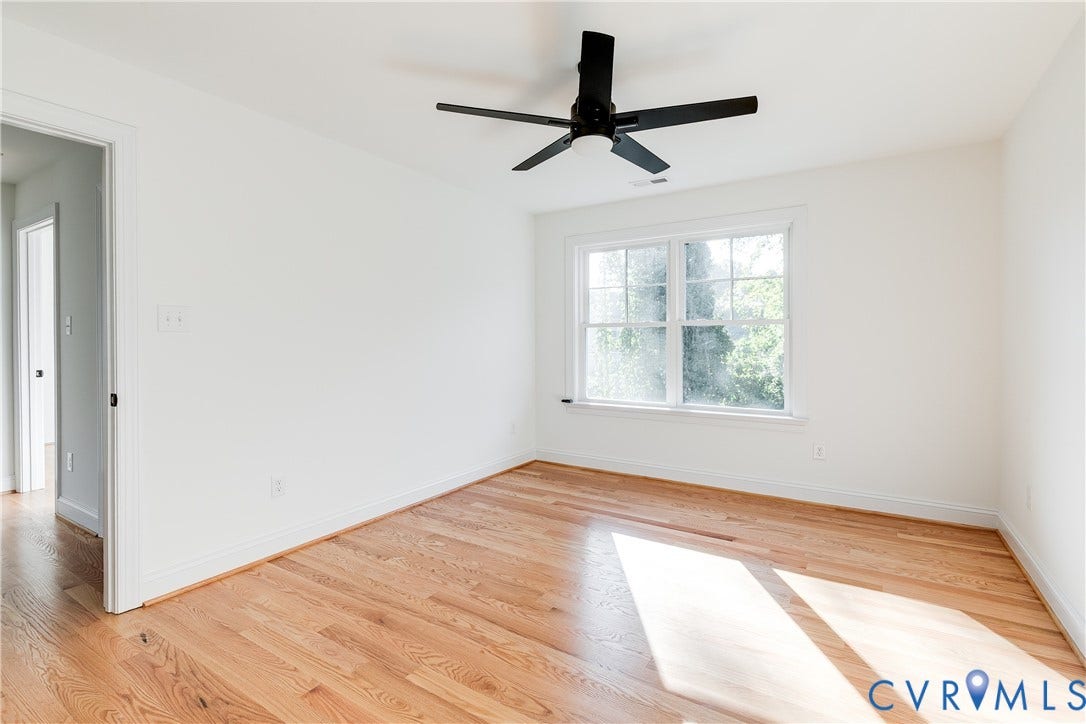 637 Ellens Haven Alley, Highland Grove, Richmond, VA 23222 Interior space featuring wood-finish flooring, a multi-pane window, and a matte black ceiling fan