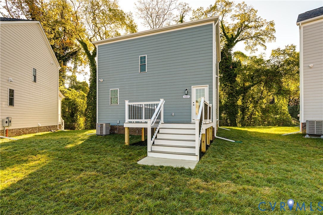 637 Ellens Haven Alley, Highland Grove, Richmond, VA 23222 Exterior elevation featuring horizontal lap siding, a raised deck with white railings, a concrete landing, and a grass-covered lot