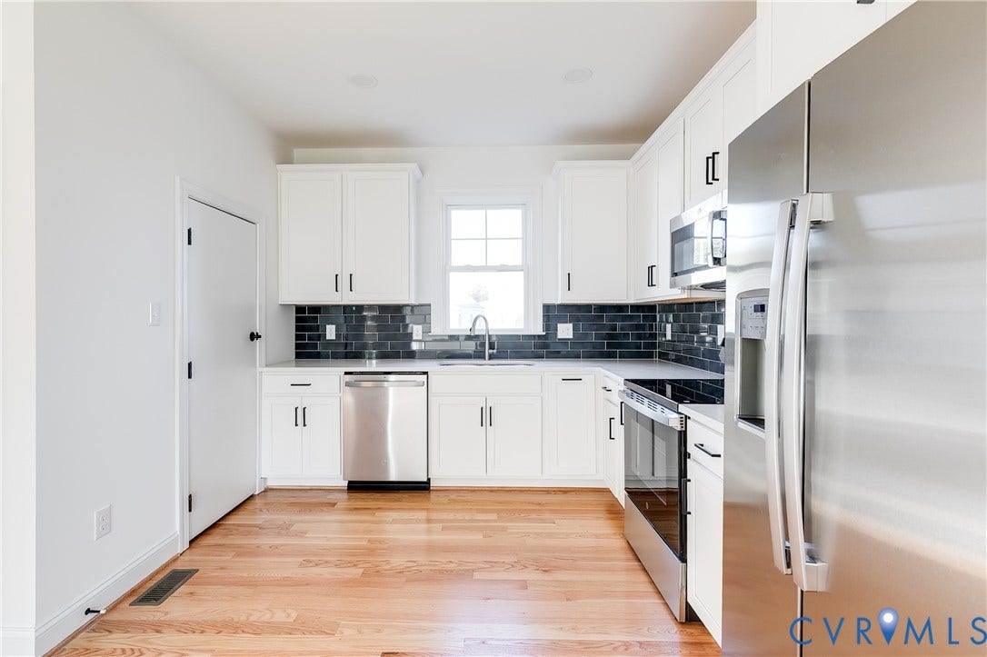 637 Ellens Haven Alley, Highland Grove, Richmond, VA 23222 Kitchen featuring white shaker-style cabinetry, stainless steel appliances, dark subway tile backsplash, light wood-finish flooring, and a single-basin sink with a gooseneck faucet