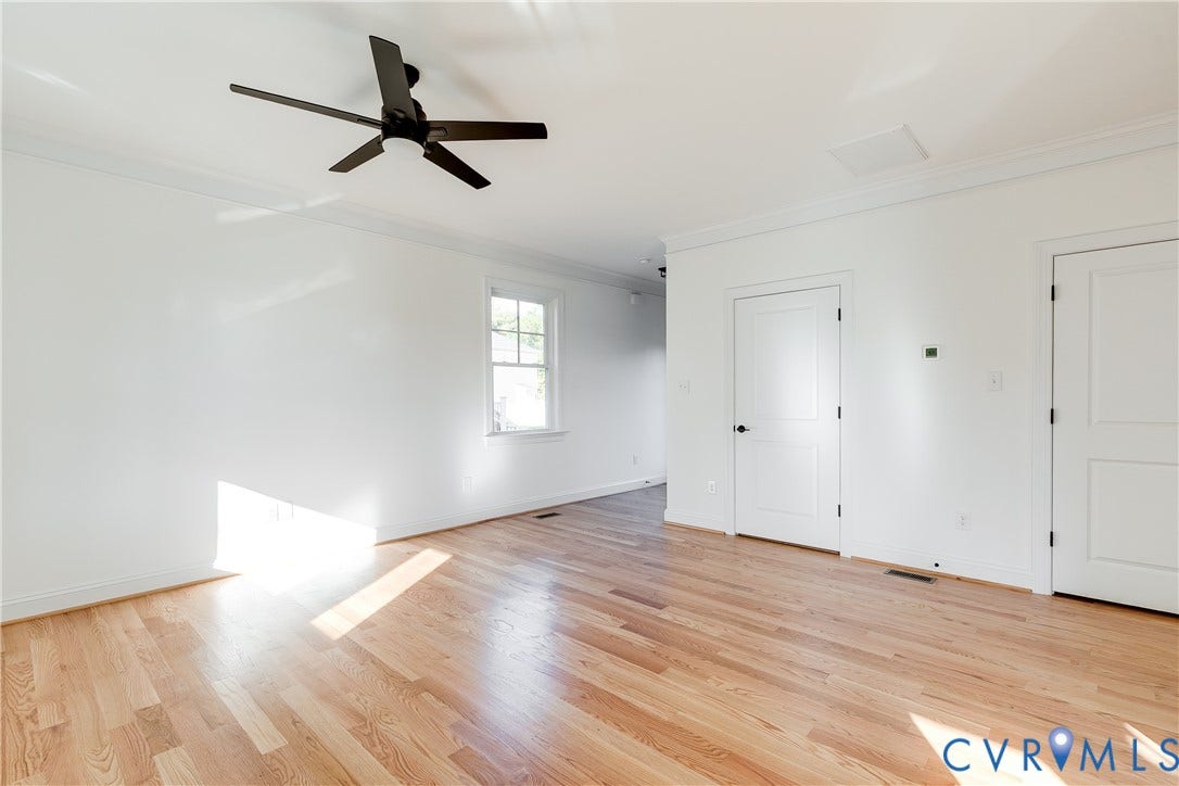 637 Ellens Haven Alley, Highland Grove, Richmond, VA 23222 Interior space featuring wood-finish flooring, a matte black ceiling fan, crown molding, and two-panel interior doors