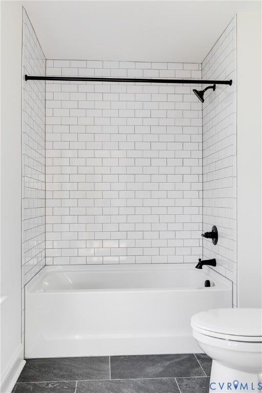 637 Ellens Haven Alley, Highland Grove, Richmond, VA 23222 Tub and shower combination featuring white subway tile surround, matte black plumbing fixtures, and dark-toned floor tile