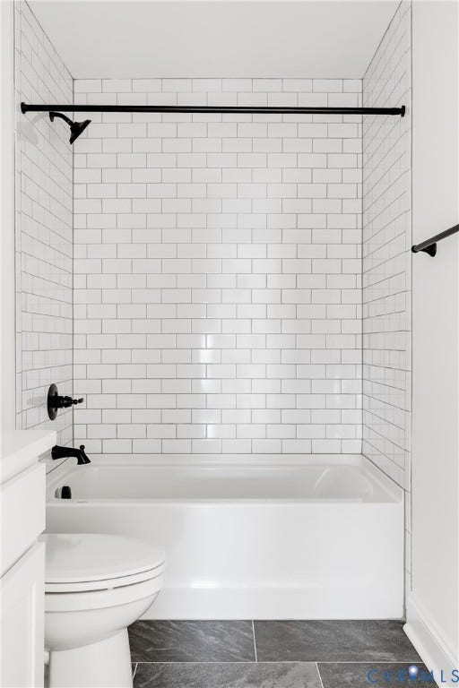 637 Ellens Haven Alley, Highland Grove, Richmond, VA 23222 Bathtub shower combination featuring white subway tile surround, matte black hardware, and dark stone-finish floor tile