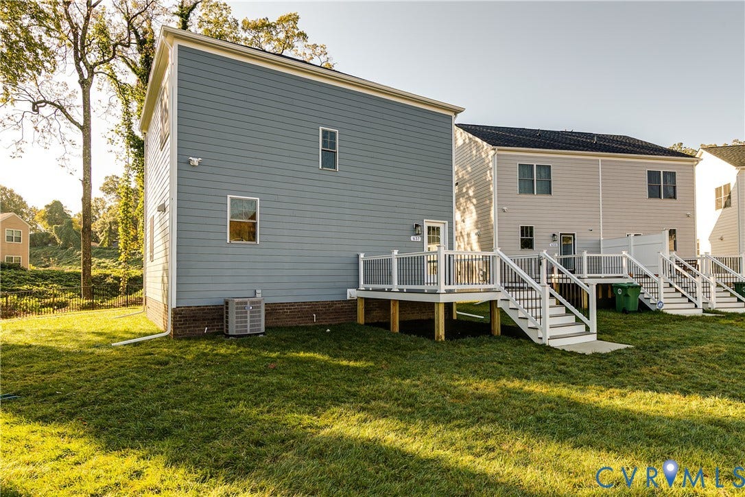 637 Ellens Haven Alley, Highland Grove, Richmond, VA 23222 Exterior featuring horizontal lap siding, a brick foundation, and a raised composite deck with white railings and staircase