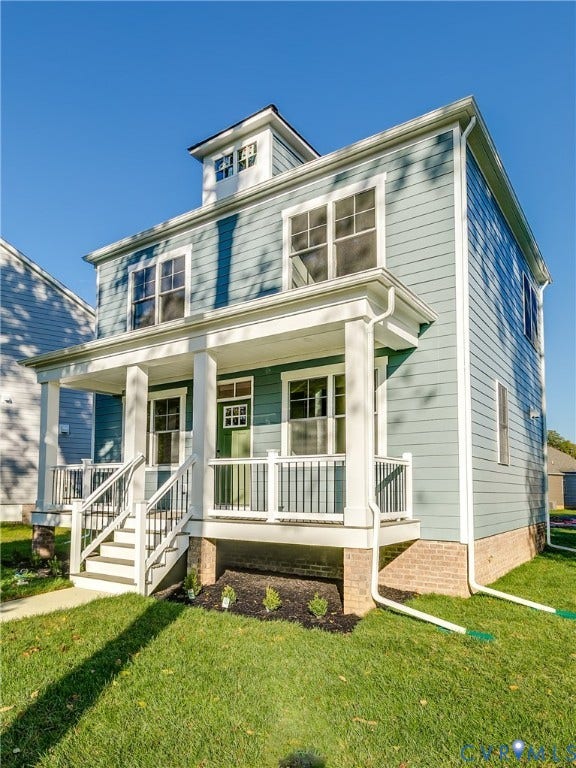 637 Ellens Haven Alley, Highland Grove, Richmond, VA 23222 Two-story residence featuring lap siding, a front porch with square columns and metal railing, a dormer window, and a stone-veneer foundation