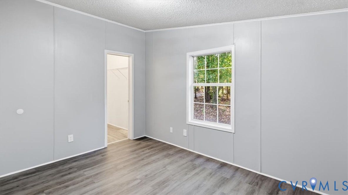75 Claybank Road, Cumberland, VA 23040 Neutral-toned paneling, wood-finish flooring, multi-pane window, and walk-in storage area