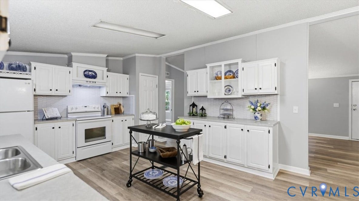 75 Claybank Road, Cumberland, VA 23040 Kitchen featuring white cabinetry with glass-front display uppers, light-toned countertop surfaces, wood-finish flooring, and integrated range hood