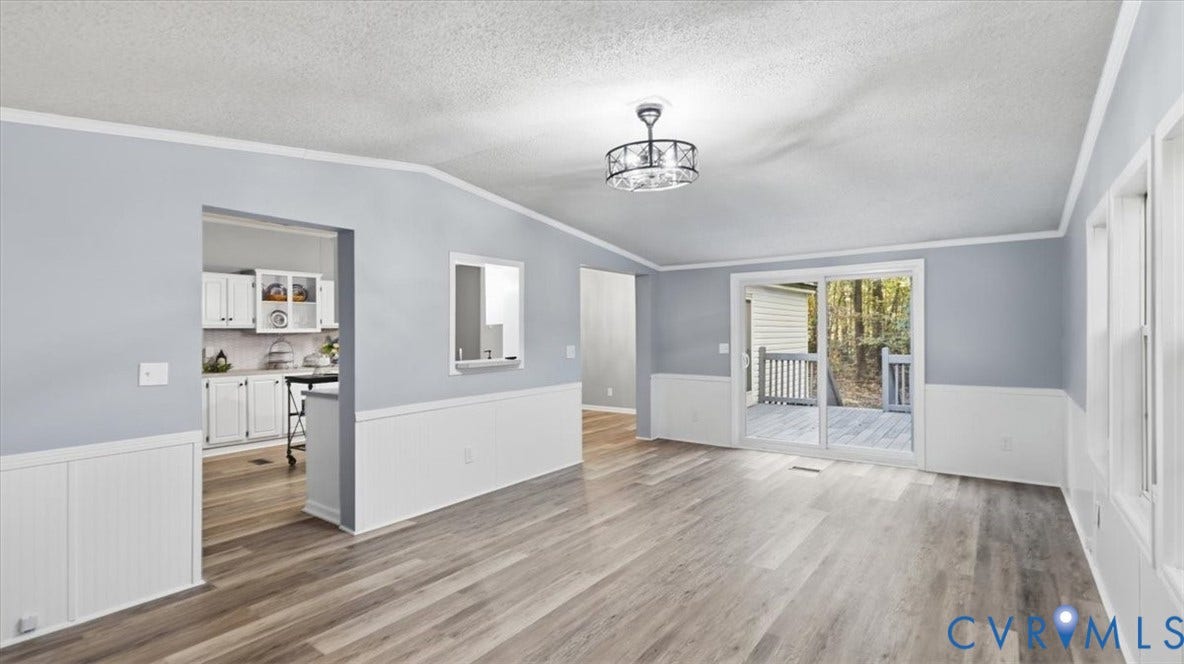 75 Claybank Road, Cumberland, VA 23040 Interior space featuring wood-finish flooring, white wainscoting, a drum-style ceiling light fixture, and sliding glass doors