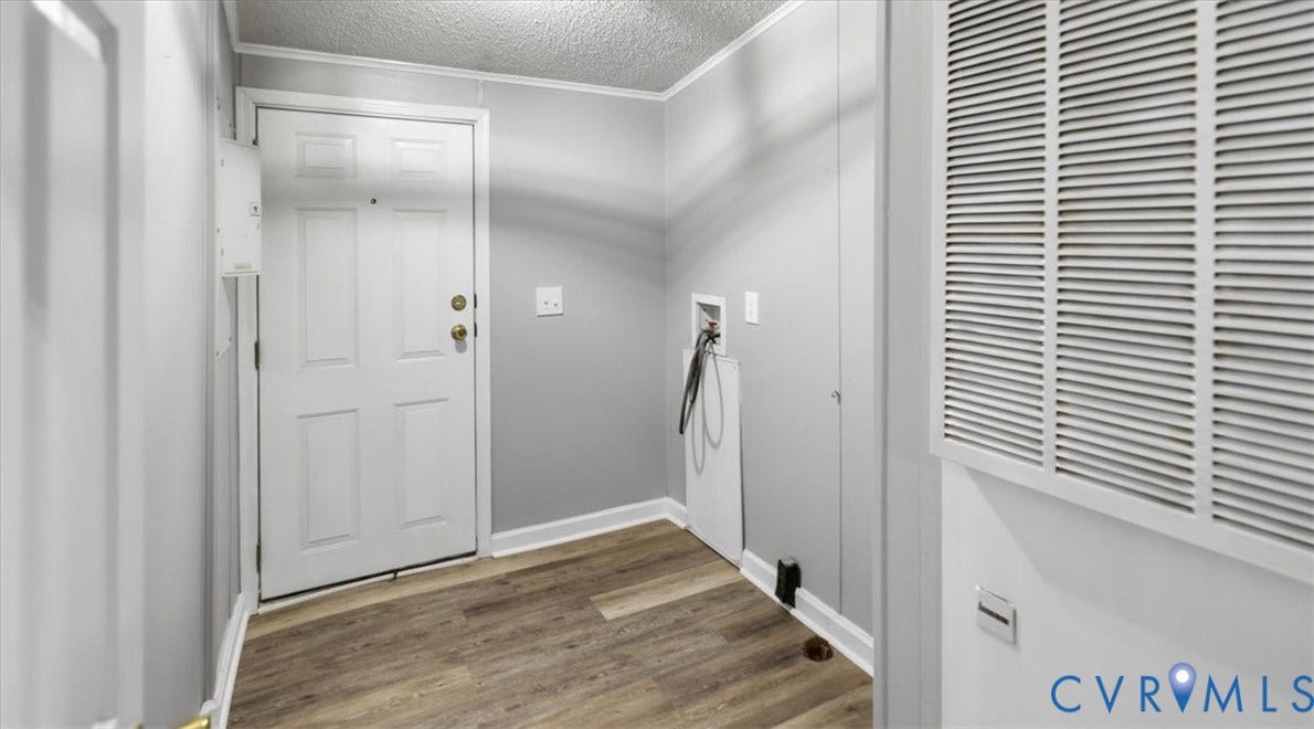 75 Claybank Road, Cumberland, VA 23040 Entryway featuring wood-finish flooring, a six-panel door with metallic hardware, and dedicated utility connections