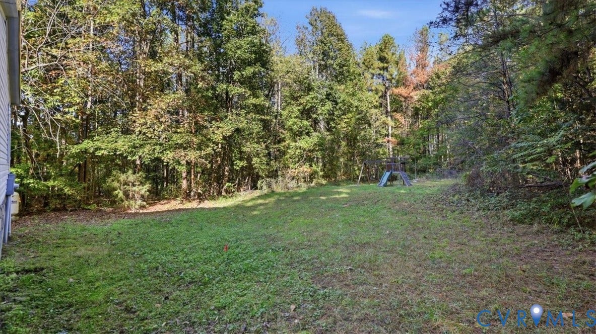 75 Claybank Road, Cumberland, VA 23040 Expansive backyard featuring an open grass area and dense perimeter of mature trees