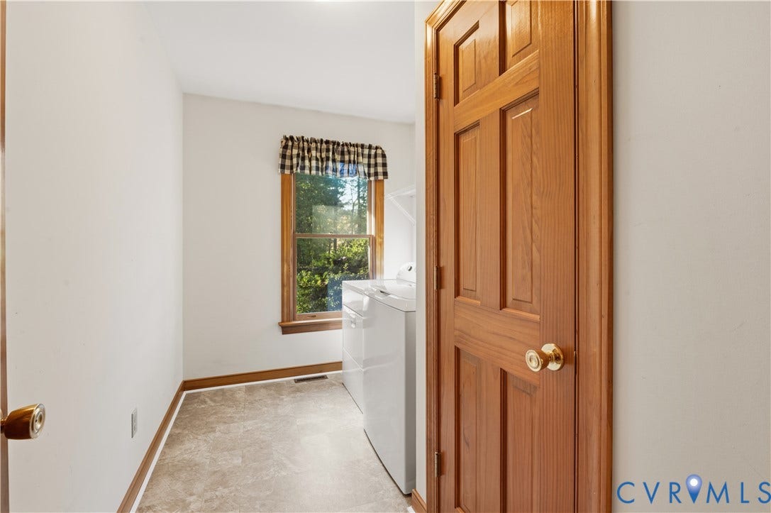 3621 Jefferson Highway, Mineral, VA 23093 Natural-finish wood six-panel door, single-hung window with wood trim, and resilient tile flooring