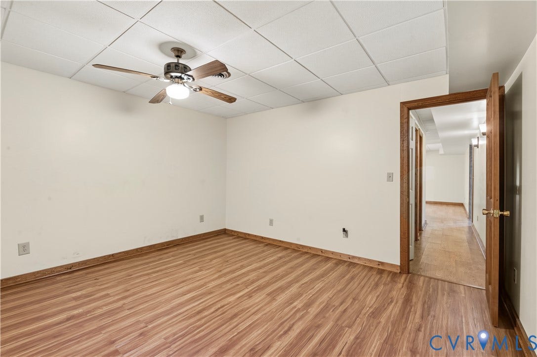 3621 Jefferson Highway, Mineral, VA 23093 Interior space featuring wood-finish flooring, a suspended acoustic tile ceiling, and a central ceiling fan with integrated lighting