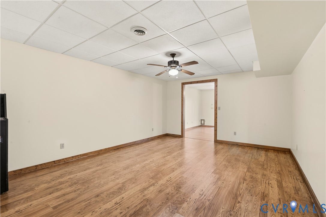 3621 Jefferson Highway, Mineral, VA 23093 Interior space featuring wood-finish flooring, a suspended acoustic tile ceiling, and a central ceiling fan with an integrated light fixture