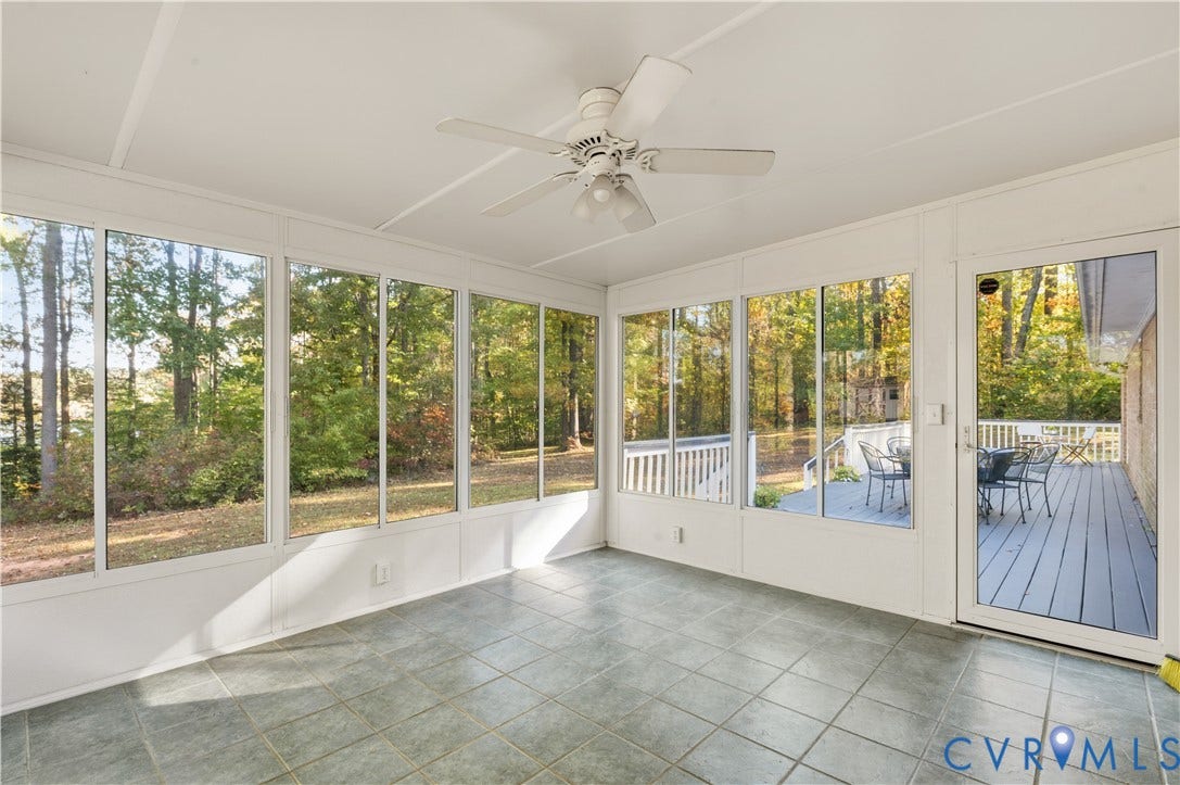 3621 Jefferson Highway, Mineral, VA 23093 Enclosed sunroom featuring large paneled windows, tiled flooring, a ceiling-mounted fan, and a glass-paneled exterior door