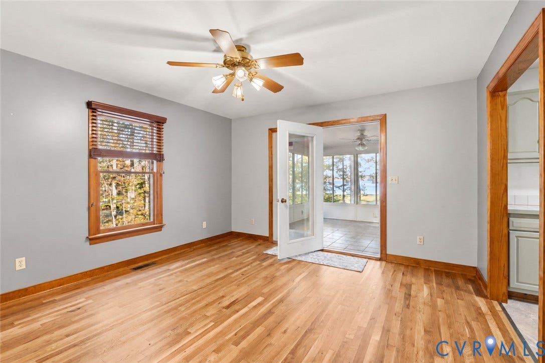 3621 Jefferson Highway, Mineral, VA 23093 Room featuring wood-finish flooring, natural wood trim, a ceiling fan with integrated lighting, and a glass-paneled door