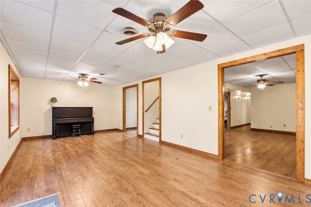 3621 Jefferson Highway, Mineral, VA 23093 Interior space featuring wood-finish flooring, drop ceiling panels, multi-light ceiling fans, and natural wood-trim doorways