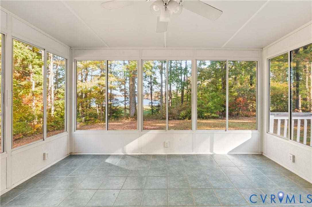3621 Jefferson Highway, Mineral, VA 23093 Enclosed sunroom featuring expansive windows, tile flooring, and a ceiling fan with integrated lighting